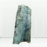 Front view of rectangular blue kyanite specimen on white background.