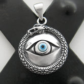 Front view of silver and blue evil eye pendant with snake border on a dark X background.