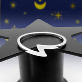 A silver ring with a sleek modern lightning bolt/thunderbolt symbol that is minimalist