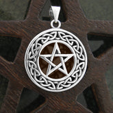 925 sterling silver pentagram pendant with Celtic knot border on wooden background