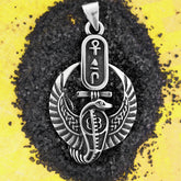 Silver pendant with Egyptian design on black and yellow background
