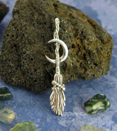 Witch's Broom or Besom w/ Crescent Moon Pendant Necklace Wiccan Wicca Pagan Witchcraft Silver Halloween Samhain Broomstick in front of black lava rock