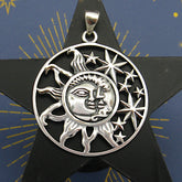 Cut-out sterling silver pendant with sun moon and stars design on dark background