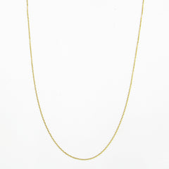 A yellow gold flat cable chain necklace  arranged in a catenary arch shown against a plain white background.