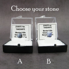 2 specimens of blue tanzanite crystals labeled in plastic boxes on dark background