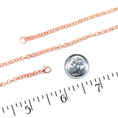 A copper rolo chain necklace with a lobster clasp and extension link, displayed on a white background with a US dime for scale and a black ruler at the bottom.