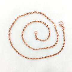 A copper figure 8 chain necklace with a lobster clasp, coiled on a plain white background.