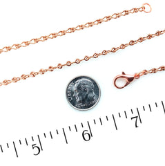 A copper chain necklace with a lobster clasp, shown next to a US dime for scale and a ruler measuring in inches on a white background.