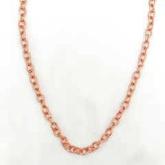 A copper chain necklace with a classic curb link pattern, displayed against a clean white background.