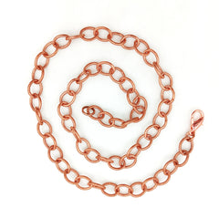 A coiled copper chain with a lobster clasp, displayed on a clean white background.