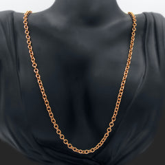 A copper cable chain hanging on a black mannequin against a white background.