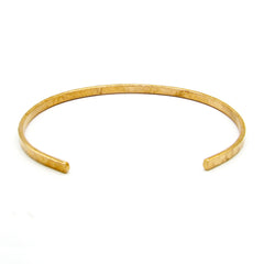 Rear/inside view of a gently hammered narrow copper open-cuff bracelet on a white background