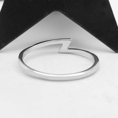 Rear view of a silver ring with a sleek modern lightning bolt/thunderbolt symbol that is  minimalist