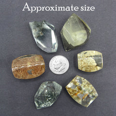 6 different Garden quartz druzy gemstones next to dime to show scale on dark background