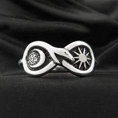 Silver Figure of Eight Snake Ring with Crescent Moon and Sun on black background.