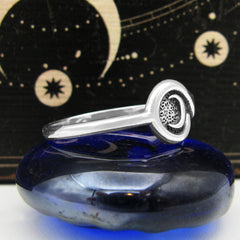 Side view of Silver Figure of Eight Snake Ring with Crescent Moon on black and yellow background.