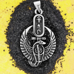 Silver pendant with Egyptian design on black and yellow background