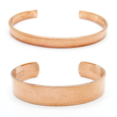 Front view of two plain polished copper open cuff bracelets, one narrow (above), one wide (below), on white background