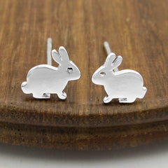 925 sterling silver hare rabbit bunny stud post earrings facing each other on a wood background