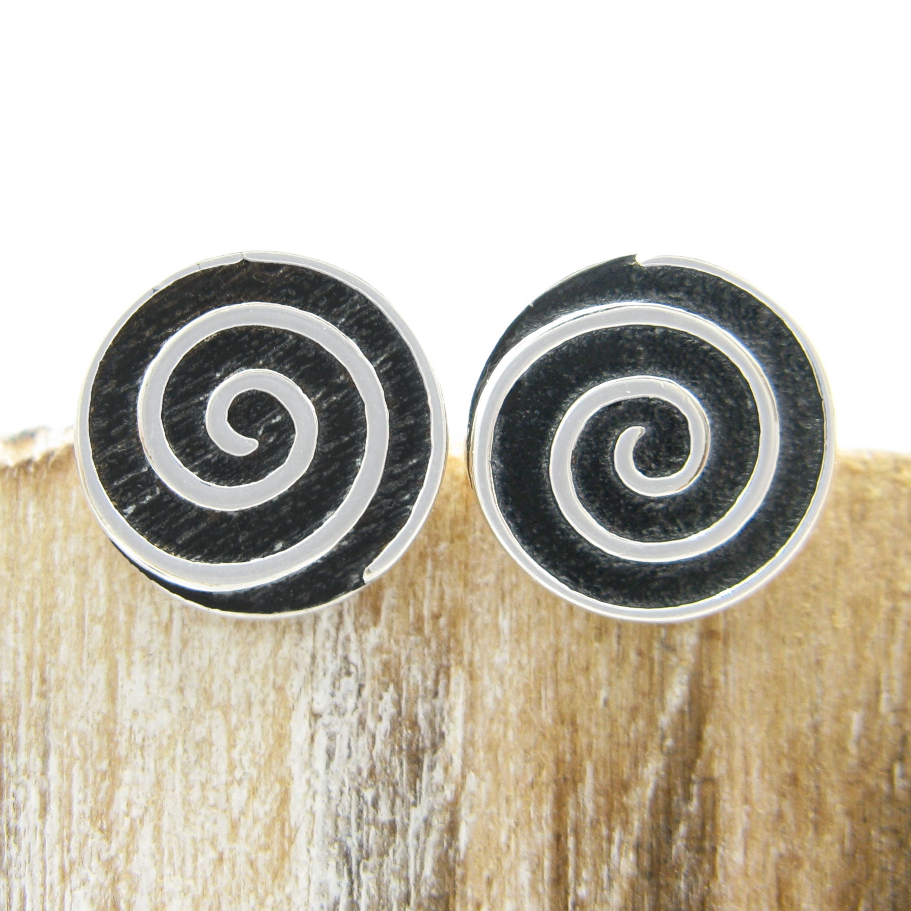 Pair of 925 sterling silver spiral stud earrings front black and silver