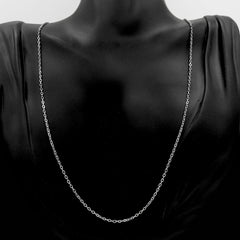 A delicate silver chain necklace displayed on a black mannequin bust against a dark background.