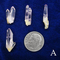 4 Examples of type A Veracruz Amethyst Crystals arranged and labeled with dime to show scale on dark background