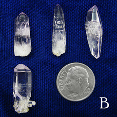 4 Examples of type B Veracruz Amethyst Crystals arranged and labeled with dime to show scale on dark background
