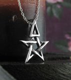 Tiny Wiccan Third Degree Pentagram Necklace High Priest Priestess Pentacle Witchcraft Witch Jewelry oblique view in front of a burgundy candle