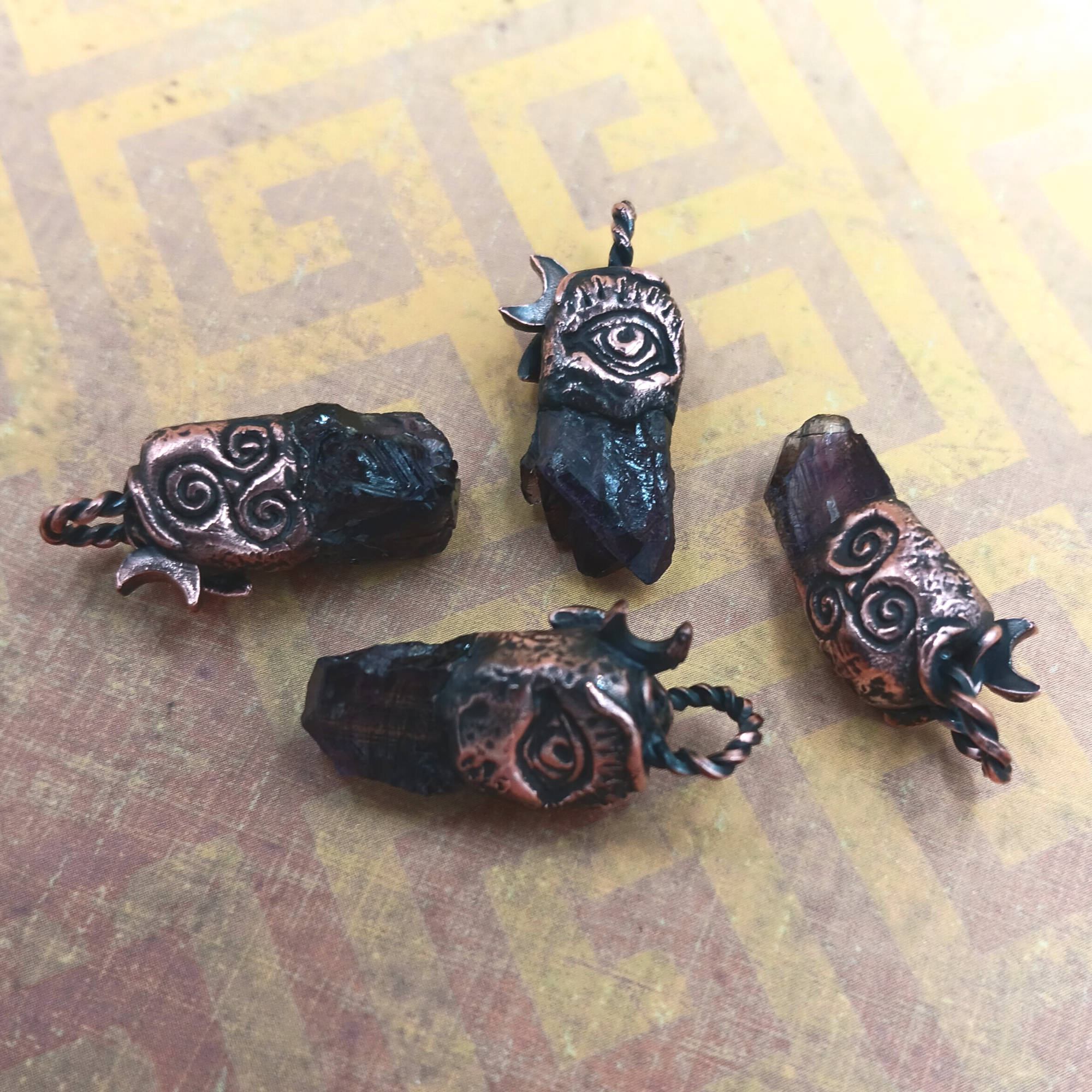 Little Copper Moon & Vines Amethyst Pendant scattered, showing backsides