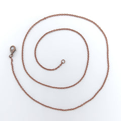oxidized dainty copper necklace shown as a coil