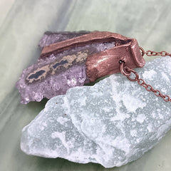 Raw triangle amethyst stalactite copper electroformed pendant showing side with bail