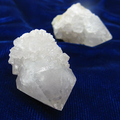 Close up picture of two Spirit Quartz crystals randomly arranged on dark background.