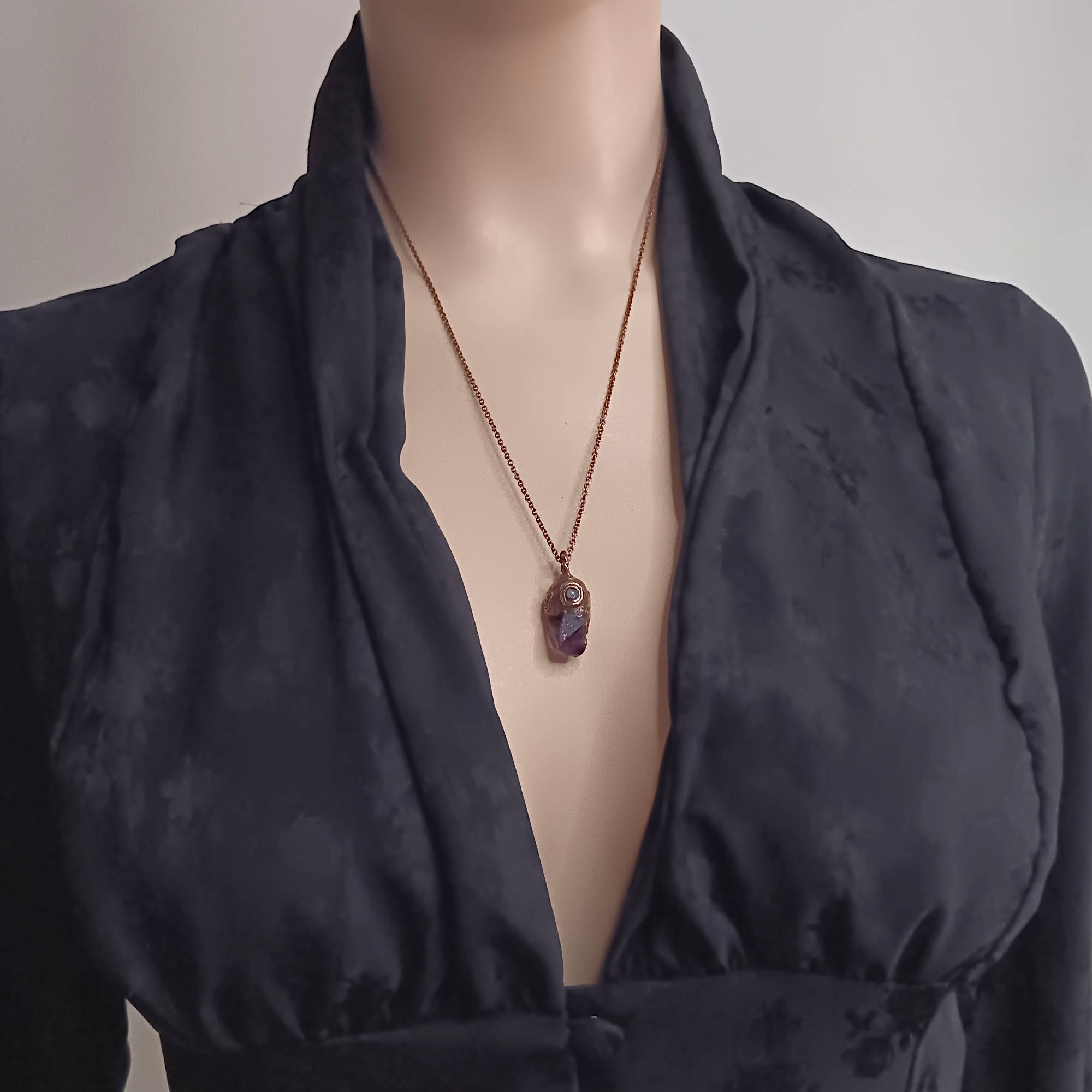 tiny raw amethyst crystal moonstone copper pendant shown being worn 