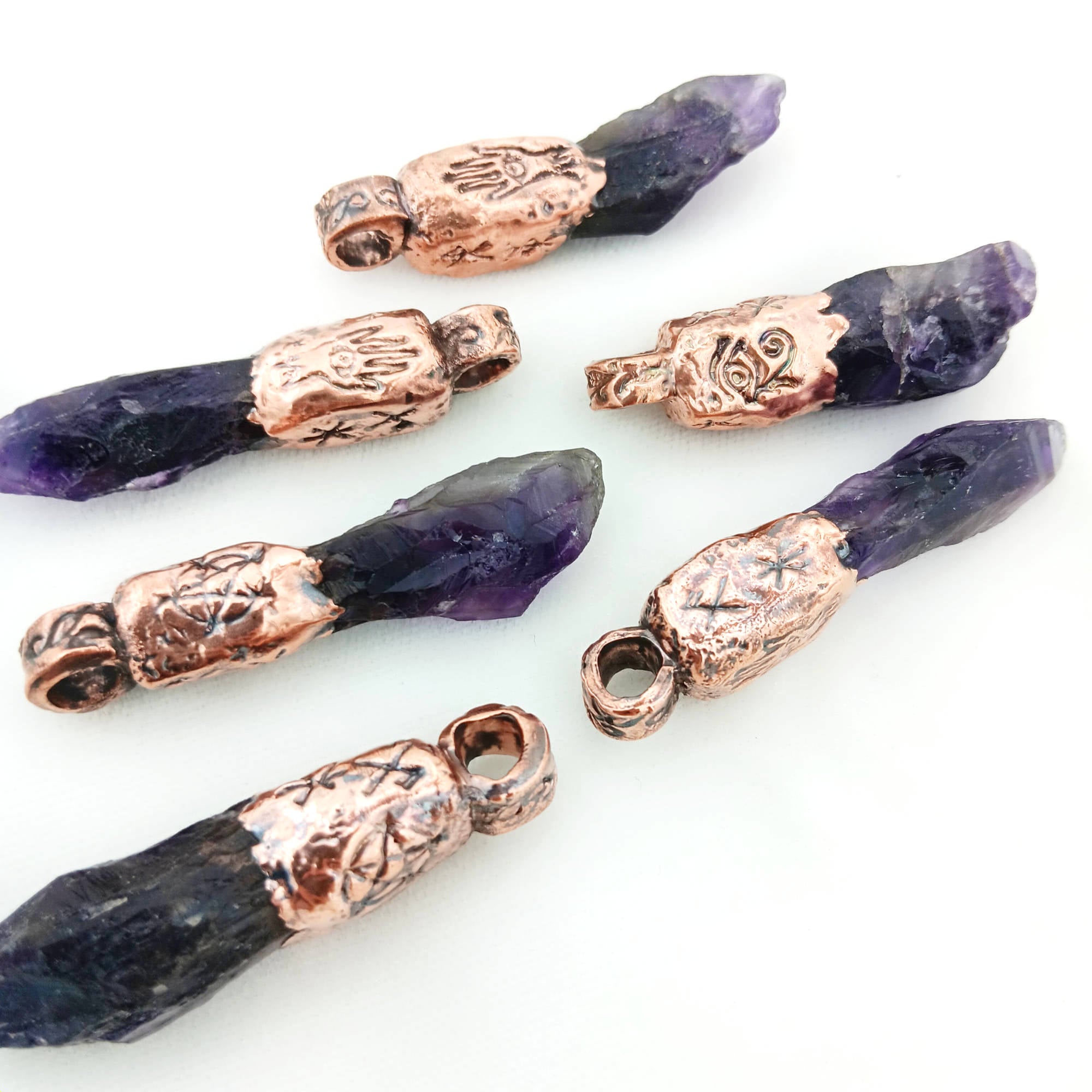 Raw grape-purple amethyst pendant with copper electroform, featuring pentagram and protective symbols for safe travels and spiritual strength.