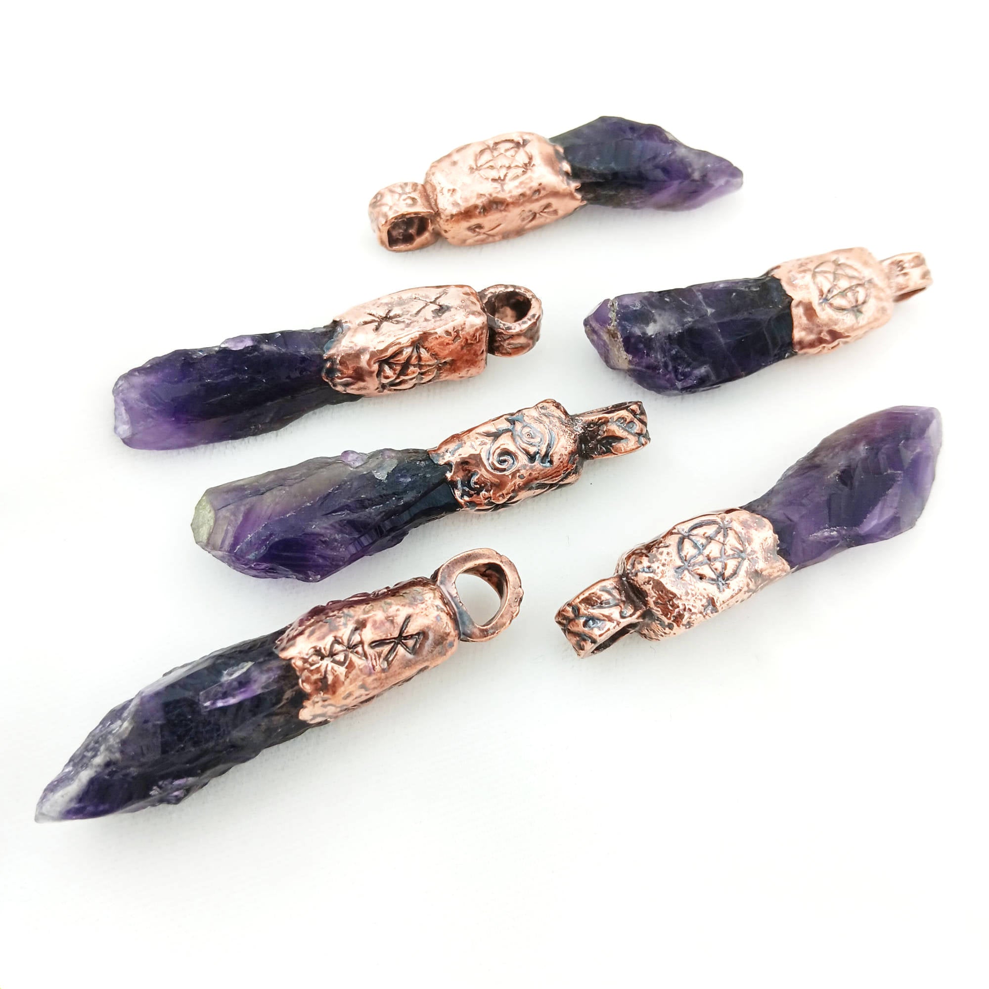 Amethyst crystal talisman pendant with copper cap and protective engravings, designed for meditation, energy work, and everyday wear.
