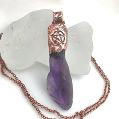 Raw amethyst crystal pendant with copper cap, pentagram stamp, and bindrunes for protection, safe travels, strength, and good luck.
