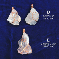 Three rose quartz pendants with copper wire wrapping on a blue fabric background, showing measurements.