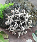 Tribal Sun Pentacle Necklace Pentagram Pendant Wiccan Wicca Star Pagan Witchcraft White Witch Witchy Jewelry Amulet Gothic in front of pumice with green stones